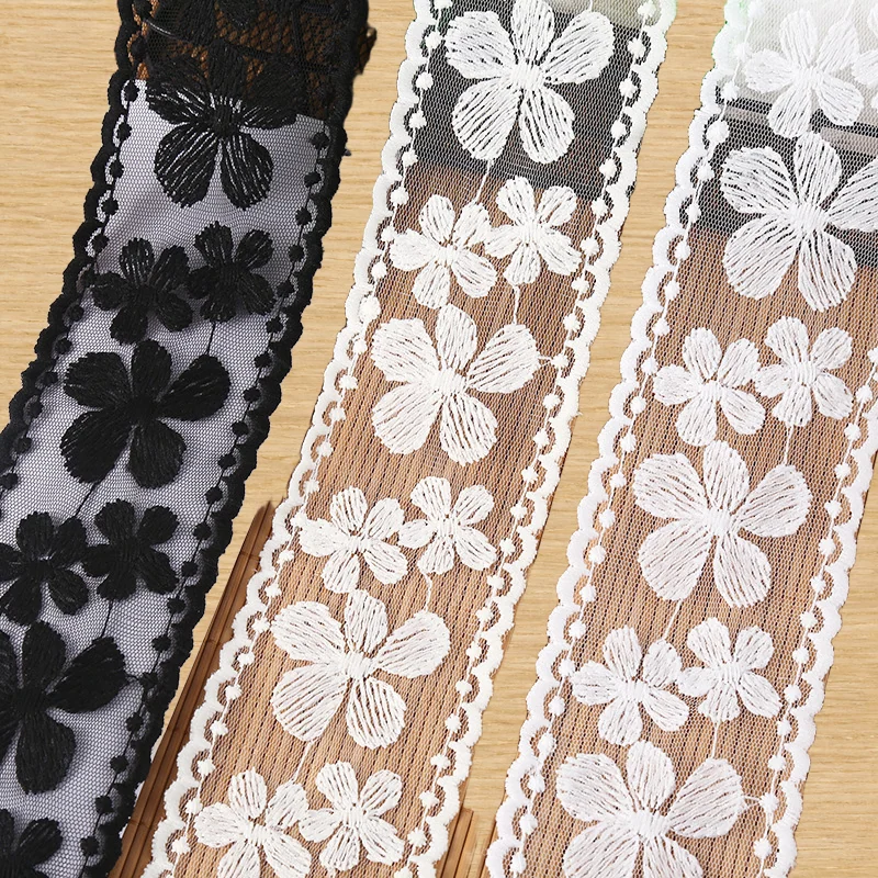 Black and white mixed flowers lace trim — Photographed decorative trim sample; verify colour and construction with a physical sample