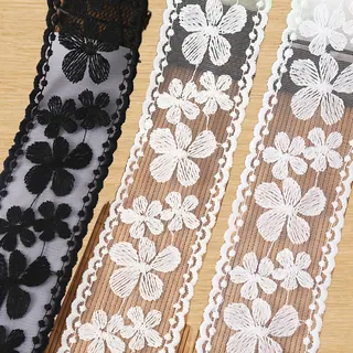 Black and white mixed flowers lace trim — Photographed decorative trim sample; verify colour and construction with a physical sample