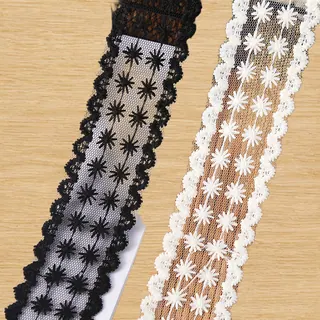 Black and white star flowers mesh trim — Photographed decorative trim sample; verify colour and construction with a physical sample