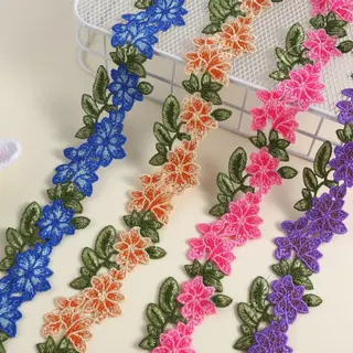 Bright multicolour flower vines lace trim — Photographed decorative trim sample; verify colour and construction with a physical sample