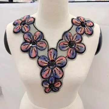 Colourful Floral Neckline Panel — Neckline panel placed on a dress form; not a finished garment