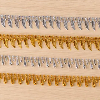 Gold and Silver Teardrop Charm Fringe Trim — Photographed decorative trim sample; verify colour and construction with a physical sample