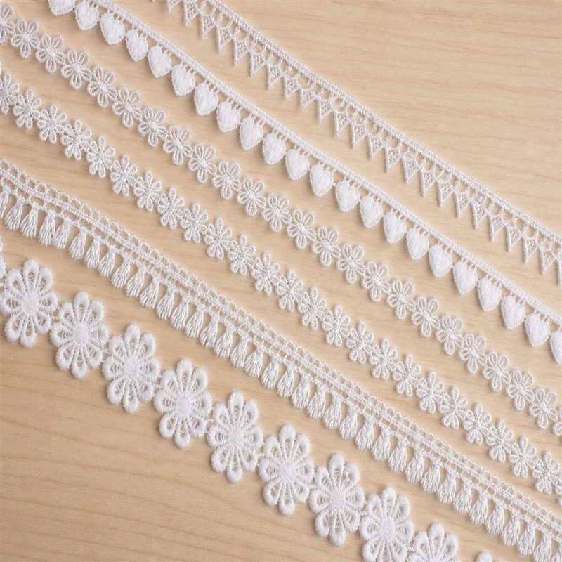 Ivory petal flowers lace trim — Photographed decorative trim sample; verify colour and construction with a physical sample
