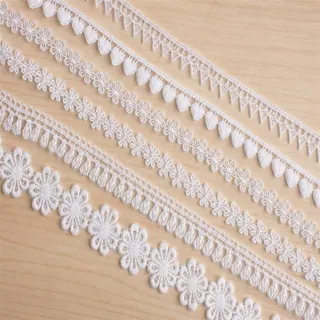 Ivory petal flowers lace trim — Photographed decorative trim sample; verify colour and construction with a physical sample