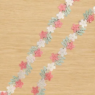 Soft pastel linked blossoms lace trim — Photographed decorative trim sample; verify colour and construction with a physical sample