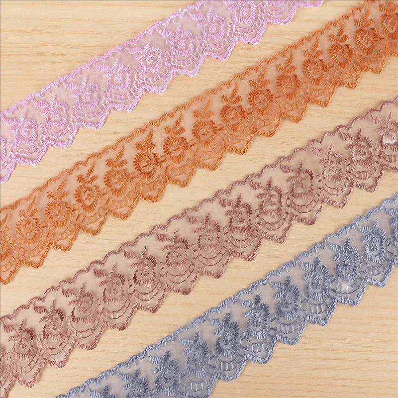 Soft pastel metallic flowers lace trim — Photographed decorative trim sample; verify colour and construction with a physical sample
