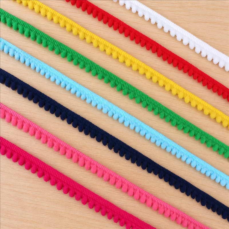 Rainbow tones pom-pom line trim — Photographed decorative trim sample; verify colour and construction with a physical sample