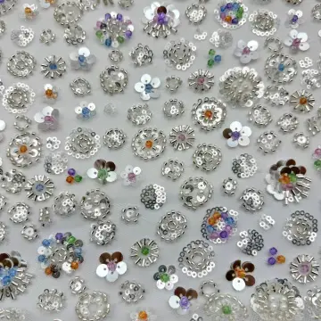 Silver Floral Disc and Bead Mesh Fabric — Close-up of the photographed surface
