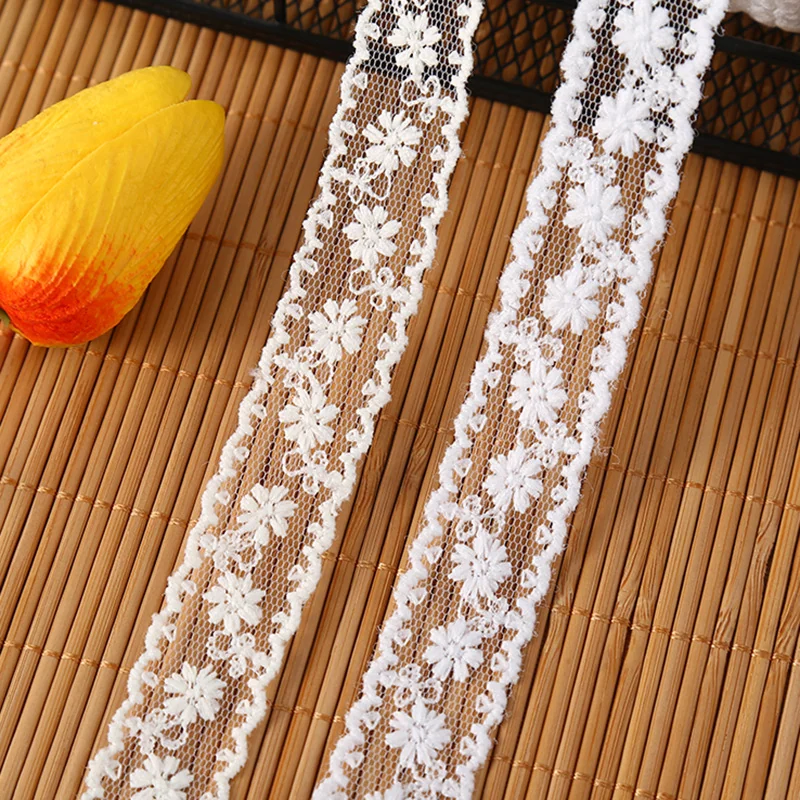 White paired flowers lace trim — Photographed decorative trim sample; verify colour and construction with a physical sample